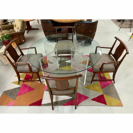 Round lucite dining table with four walnut dining chairs