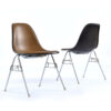 Charles Eames for Herman Miller fiberglass shell chairs with brown Naugahyde pads and black fiberglass