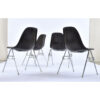 Back view of Charles Eames for Herman Miller black fiberglass shell chairs with brown Naugahyde seat pads