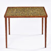 green yellow and black small tiles on Danish teak end table