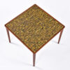 One inch green yellow black and brown Scandinavian mosaic tiles on teak end table