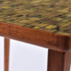 Scratches along the edge of Danish teak tile top side table