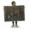 Leopard painting being held up by a woman