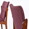 Seat backs of Danish teak dining chairs in plum fabric