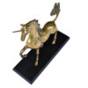Looking down on large brass unicorn figurine on wood base