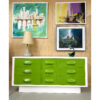 Green Broyhill Chapter One triple dresser surrounded by paintings