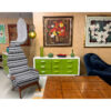Green and white Broyhill Chapter One triple dresser surrounded by paintings