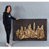 Woman standing next to Finesse Originals cityscape wall art