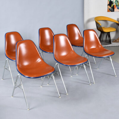 Eames red orange naugahyde pad DSS stacking chairs from Eastern Airlines