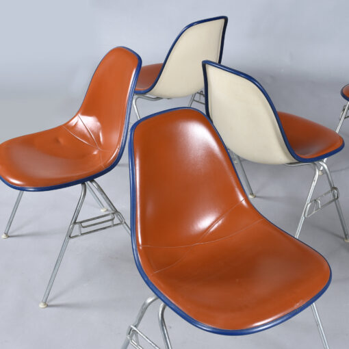 Eames red orange naugahyde pad DSS stacking chairs from Eastern Airlines