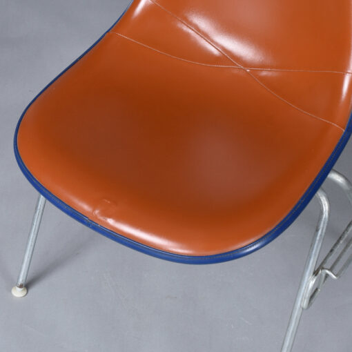 Eames red orange naugahyde pad DSS stacking chairs from Eastern Airlines