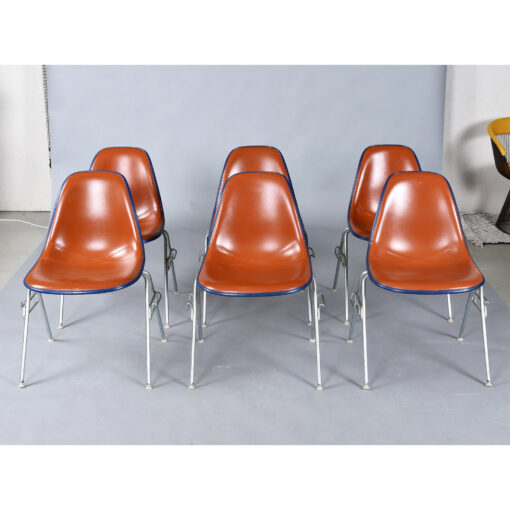 Eames red orange naugahyde pad DSS stacking chairs from Eastern Airlines