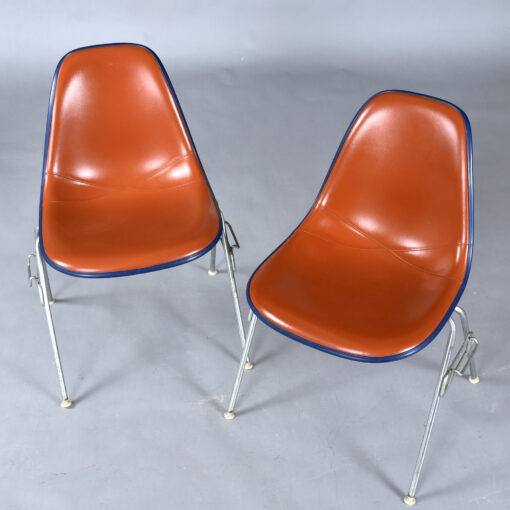 Eames red orange naugahyde pad DSS stacking chairs from Eastern Airlines