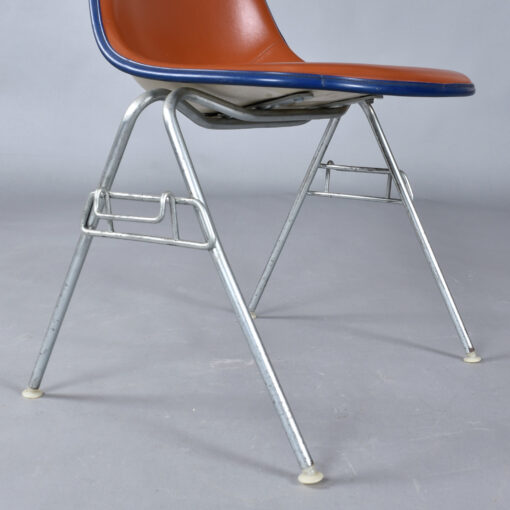 Eames red orange naugahyde pad DSS stacking chairs from Eastern Airlines